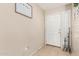 Bright foyer featuring a white door, tile flooring, plantation shutters and decorative home decor at 2813 N 107Th Dr, Avondale, AZ 85392