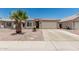 Charming single-story home with desert landscaping, mature palm tree, and a two-car garage at 2813 N 107Th Dr, Avondale, AZ 85392