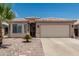 Charming single-story home with desert landscaping, mature palm tree, and a two-car garage at 2813 N 107Th Dr, Avondale, AZ 85392
