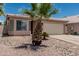 Charming single-story home with desert landscaping, mature palm tree, and a two-car garage at 2813 N 107Th Dr, Avondale, AZ 85392