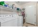 Functional laundry room with washer, dryer, shelving, and direct access to the exterior for added convenience at 2813 N 107Th Dr, Avondale, AZ 85392
