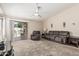 Inviting living room with a ceiling fan, plush carpeting, slider, and comfortable seating at 2813 N 107Th Dr, Avondale, AZ 85392