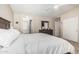 Main bedroom featuring a ceiling fan, closet, bathroom and wooden furniture at 2813 N 107Th Dr, Avondale, AZ 85392
