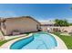 Beautiful swimming pool with clean lines, poolside patio, and a well kept artificial turf area at 2813 N 107Th Dr, Avondale, AZ 85392
