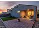 Backyard with brick patio, a fire pit, and an outdoor seating area under a covered patio at 29819 W Whitton Ave, Buckeye, AZ 85396