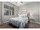 Cozy bedroom with large windows, a ceiling fan, and a comfy bed with decorative pillows at 29819 W Whitton Ave, Buckeye, AZ 85396