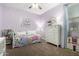 Lovely bedroom with a daybed, a white dresser, rainbow accents, and a charming dollhouse at 29819 W Whitton Ave, Buckeye, AZ 85396