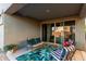 Inviting covered patio featuring comfortable seating, a stylish rug, and sliding glass doors for seamless indoor-outdoor living at 29819 W Whitton Ave, Buckeye, AZ 85396