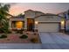 Beautiful single-story home with desert landscaping, a two-car garage and well-lit exterior at 29819 W Whitton Ave, Buckeye, AZ 85396