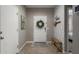 Cozy foyer featuring tiled floors, a decorative wreath and bench seating at 29819 W Whitton Ave, Buckeye, AZ 85396