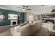 Modern living room featuring a fireplace, decorative shelving, and an open layout to the dining area and kitchen at 29819 W Whitton Ave, Buckeye, AZ 85396