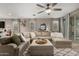 Spacious living room with neutral tones, an oversized sectional sofa, and large windows offering plenty of natural light at 29819 W Whitton Ave, Buckeye, AZ 85396