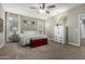 Inviting main bedroom with a decorative dresser, ceiling fan, and large window offering natural light at 29819 W Whitton Ave, Buckeye, AZ 85396