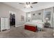 Comfortable main bedroom with neutral walls, a walk-in closet, a ceiling fan, and natural light at 29819 W Whitton Ave, Buckeye, AZ 85396