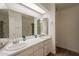 Well-lit bathroom with double sink vanity, a large mirror, and a combined shower and tub at 310 E Fremont Dr, Tempe, AZ 85282