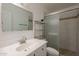 Bright bathroom featuring a vanity with a white cabinet, a large mirror, and a glass enclosed shower at 310 E Fremont Dr, Tempe, AZ 85282