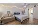 Comfortable bedroom featuring a cozy bed, neutral-toned sofa, closet and doorway to dining room at 310 E Fremont Dr, Tempe, AZ 85282