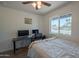 Bright bedroom with wood floors, a ceiling fan, a window view, and a work space with dual monitors at 310 E Fremont Dr, Tempe, AZ 85282