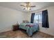 Inviting bedroom with wood floors, a side table, and large window with curtains at 310 E Fremont Dr, Tempe, AZ 85282