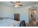 A clean and cozy bedroom features wood floors, a ceiling fan, a closet, and a dresser for ample storage at 310 E Fremont Dr, Tempe, AZ 85282