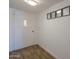 The home's entryway includes a white front door with an interior glass panel, wood floors, and light gray walls at 310 E Fremont Dr, Tempe, AZ 85282