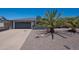 Exterior featuring a well-maintained home, desert-style landscaping, and a front-entry two-car garage at 310 E Fremont Dr, Tempe, AZ 85282