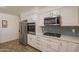 Bright kitchen featuring stainless steel appliances, white cabinets and subway tile backsplash at 310 E Fremont Dr, Tempe, AZ 85282
