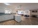 Bright open kitchen with breakfast bar flows into dining area and living room at 310 E Fremont Dr, Tempe, AZ 85282