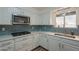 Close up of the kitchen with gas cooktop, subway tile backsplash and stainless steel sink at 310 E Fremont Dr, Tempe, AZ 85282