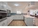 Open kitchen with breakfast bar, stainless appliances and stylish tile flooring at 310 E Fremont Dr, Tempe, AZ 85282