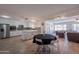 Open-concept living room and kitchen with stainless steel appliances and a view of the pool table at 310 E Fremont Dr, Tempe, AZ 85282
