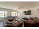 Spacious living room with a billiards table, leather sofas, and large windows at 310 E Fremont Dr, Tempe, AZ 85282