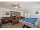 Open-concept living space features pool table, comfortable seating, and easy access to other rooms at 310 E Fremont Dr, Tempe, AZ 85282