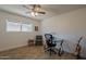 Well-lit home office with wood floors, a modern desk setup, and neutral-toned chair at 310 E Fremont Dr, Tempe, AZ 85282