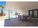 Covered outdoor patio with a table, chairs, a view of the pool, and a manicured lawn at 310 E Fremont Dr, Tempe, AZ 85282