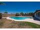 Inviting private backyard pool with cool blue water, and grass with block fence at 310 E Fremont Dr, Tempe, AZ 85282
