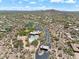 Aerial view of the community entrance, clubhouse, pool, and tennis courts surrounded by homes and desert landscaping at 31107 N 72Nd Pl, Scottsdale, AZ 85266