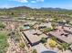 An aerial view of a beautiful home surrounded by desert landscaping and community views with mountainous backdrops at 31107 N 72Nd Pl, Scottsdale, AZ 85266