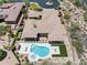 Aerial view of a luxury home showcasing the pool, patio, desert landscaping, and surrounding neighborhood at 31107 N 72Nd Pl, Scottsdale, AZ 85266