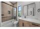 Modern bathroom featuring a glass shower, wood tile surround, and sleek countertop at 31107 N 72Nd Pl, Scottsdale, AZ 85266