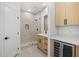 Modern bathroom with a glass shower, wooden vanity, and convenient built-in wine cooler at 31107 N 72Nd Pl, Scottsdale, AZ 85266
