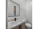 Powder bathroom featuring a stylish sink, faucet, vanity, toilet, and a modern mirror at 31107 N 72Nd Pl, Scottsdale, AZ 85266