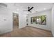 Bright bedroom with wood floors, ceiling fan, and large windows overlooking a landscaped yard at 31107 N 72Nd Pl, Scottsdale, AZ 85266