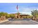 Stone community entrance with U.S. flag and native landscaping at 31107 N 72Nd Pl, Scottsdale, AZ 85266