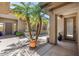 Exterior courtyard featuring palm trees, desert landscaping, and stone pavers leading to the front entrance at 31107 N 72Nd Pl, Scottsdale, AZ 85266