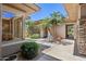 Home exterior showcasing a private courtyard with palm trees, desert landscaping, and stone pavers at 31107 N 72Nd Pl, Scottsdale, AZ 85266