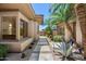 Exterior walkway and courtyard area with desert landscaping, palm trees, and a view of the home's exterior at 31107 N 72Nd Pl, Scottsdale, AZ 85266