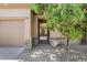 Home entrance featuring desert landscaping, a walkway to the front door, and a three-car garage at 31107 N 72Nd Pl, Scottsdale, AZ 85266
