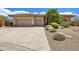 Desert-style home exterior featuring a three-car garage, mature desert landscaping, and a neutral color palette at 31107 N 72Nd Pl, Scottsdale, AZ 85266
