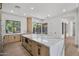 Bright kitchen featuring a large marble island, stainless steel appliances, and windows with backyard views at 31107 N 72Nd Pl, Scottsdale, AZ 85266